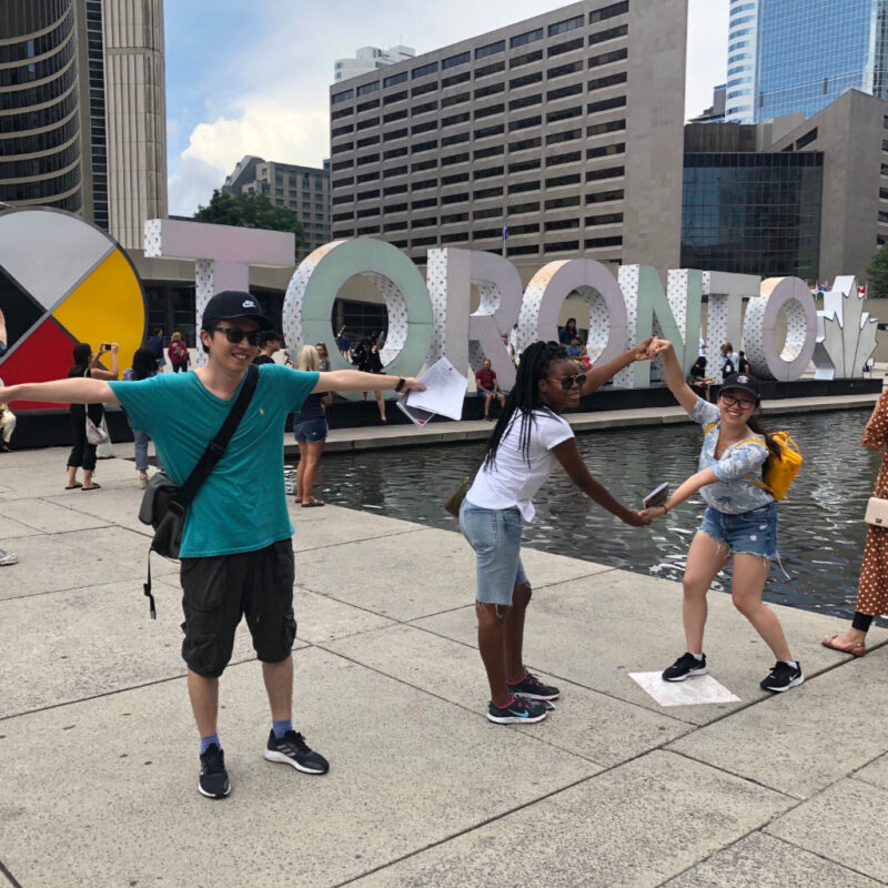 Hunt participants in front of Toronto sign