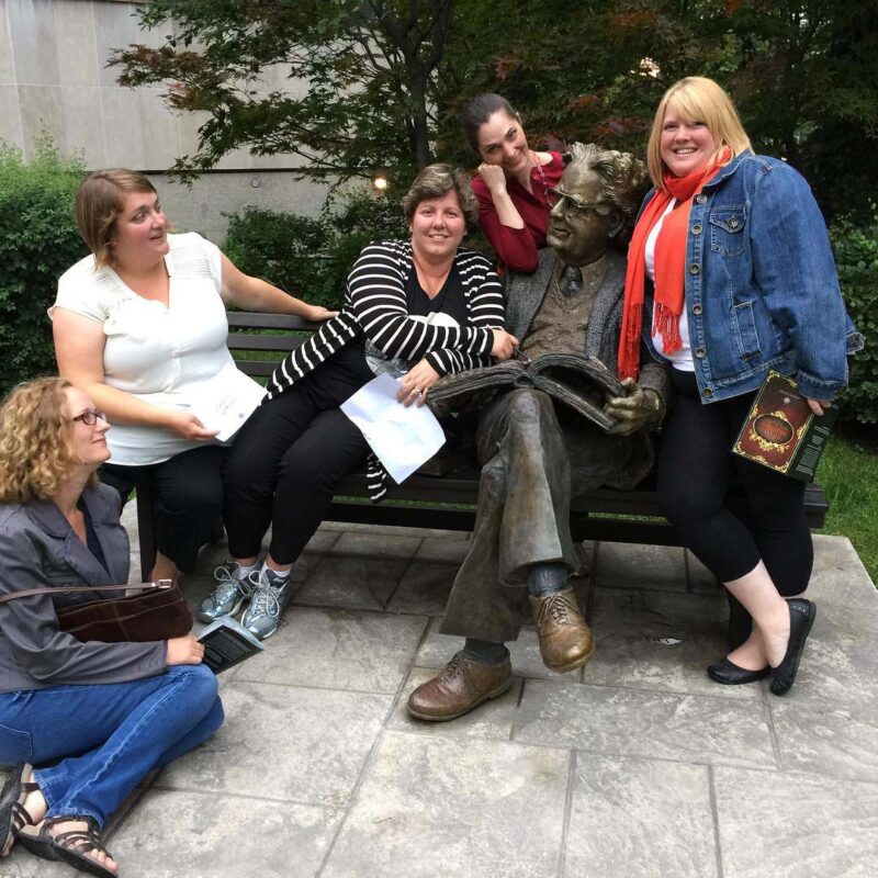 Hunt participants posing humorously with a statue
